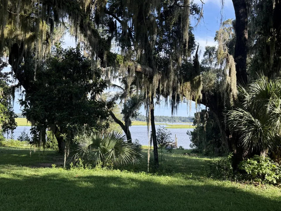 Sapelo River view from the Sapelo House lawn framed by live oak trees and Spanish moss in coastal Georgia.